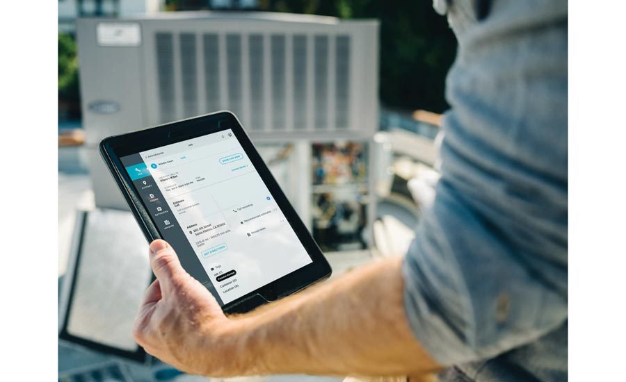 Technician adjusting smart HVAC system settings using mobile app in modern Texas home